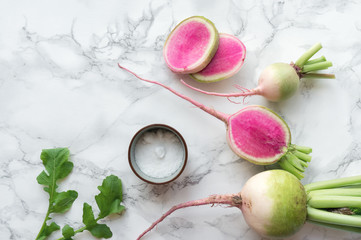 Watermelon radish (chinese daikon) on marble table. Top view. 