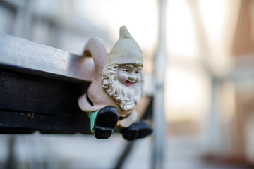 Cute and cheeky gnome pot hanger - hanging from a green house shelf