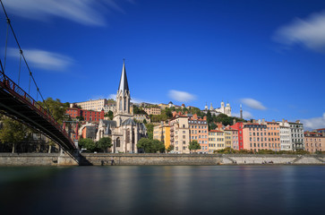 Fototapeta na wymiar Passerelle (footbridge) Saint Georges over the Saone river and the Saint Georges church in Lyon, France.