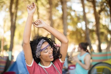 Happy woman dancing at campsite