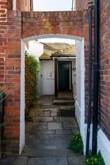 Traditional entrance door of dark green color in English town