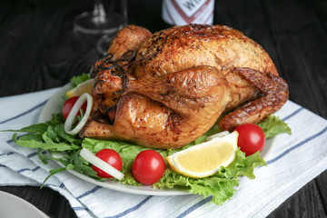 Plate with delicious roasted turkey on table