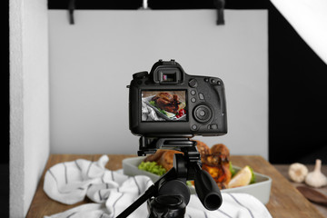 Professional camera on tripod during food photographing in studio