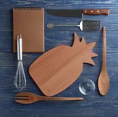 Kitchen utensils on wooden background