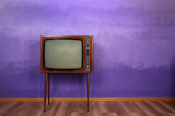 Retro TV on color wall background