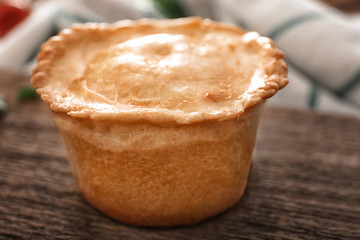 Delicious meat mini pie on board, closeup