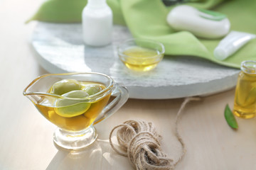 Gravy boat with olive oil on wooden table