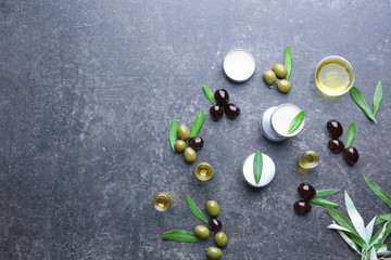 Cosmetics with olive oil extract on grunge table