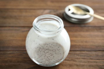 Jar with delicious chia seed pudding on table