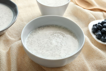 Bowl with delicious chia seed pudding on table