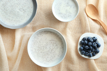 Bowls with delicious chia seed pudding on table