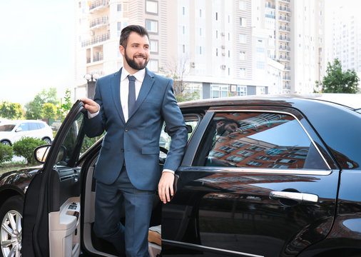 Handsome Man In Suit Getting Out Of Car