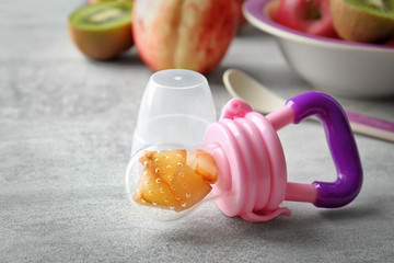 Baby's nibbler on light background