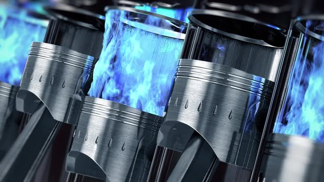 A close-up of engine in slow motion with a blue explosions of fuel