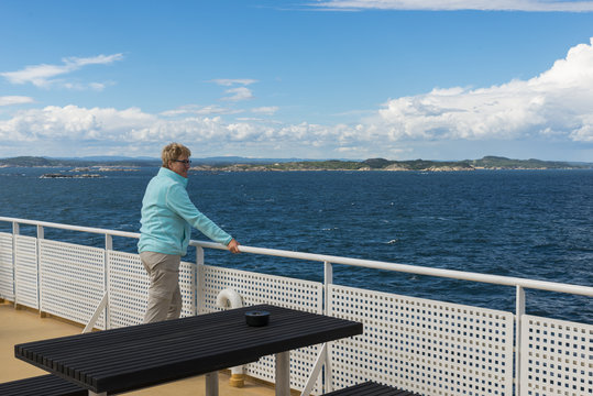 adult woman in blue sweater on ferry