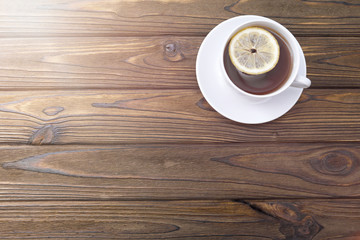 cup of tea with lemon on a wooden background