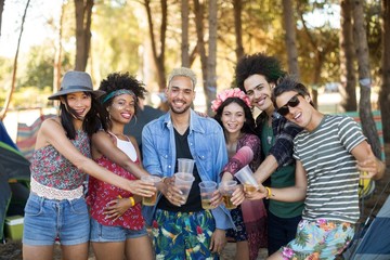 Portrait of smiling friends holding beer glasses