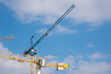 blue and yellow crane on a cloudy sky