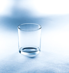 empty glass glass on a blue background