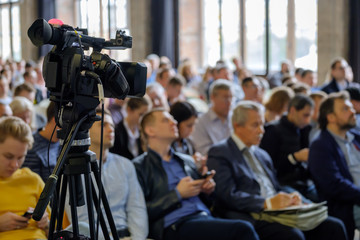 Audience at the conference, focus to the camera at foreground