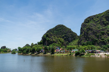 Fototapeta na wymiar Soaring limestone cliffs in Inland Haolong Bay, Ninh Binh, Vietnam.