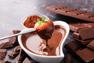 Fondue with Melting chocolate or melted chocolate and strawberry.