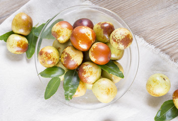 Top view of fresh jujubes fruit in a glass bowl. 