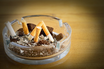 consumed cigarettes wiht coffee grounds in  ashtray