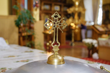 Burning candle in the church in front of the icons