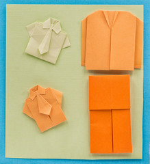 origami paper man office suit on textured background