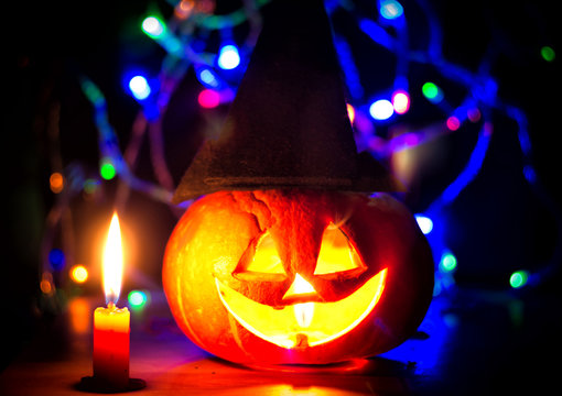 spooky halloween pumpkin with candles and shiny eye