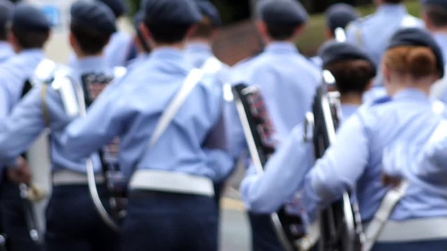 Young Air cadets marching as they play lyres with soft focus and slow motion.