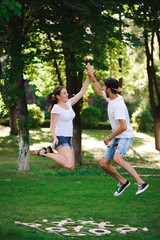 A young couple celebrate victory playing tic-tac-toe in the park