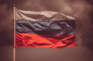 Russian flag against the sky. Flag of the Russian Federation. National symbol.