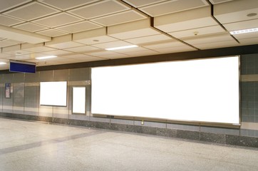 blank advertising billboard with copy space for your text message or media and content in subway train station or airport, information board, mock up banner, marketing and advertising concept