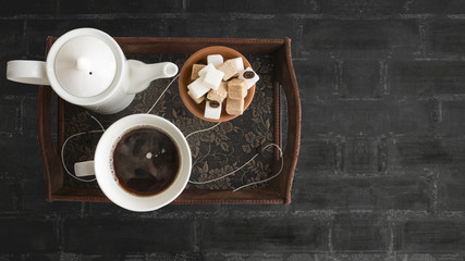 Obraz na płótnie Canvas White porcelain coffee , full cup of coffee and sugar cubes on wooden rustic table. Top view, copy space.
