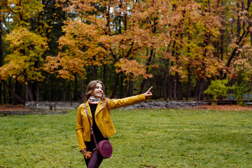 Fototapeta premium horizontal autumn portrait of a beautiful smile girl with long fair-haired hair in yellow leather jacket