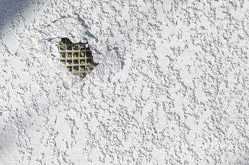 Texture of damaged white plaster pattern on a wall. Textured backdrop