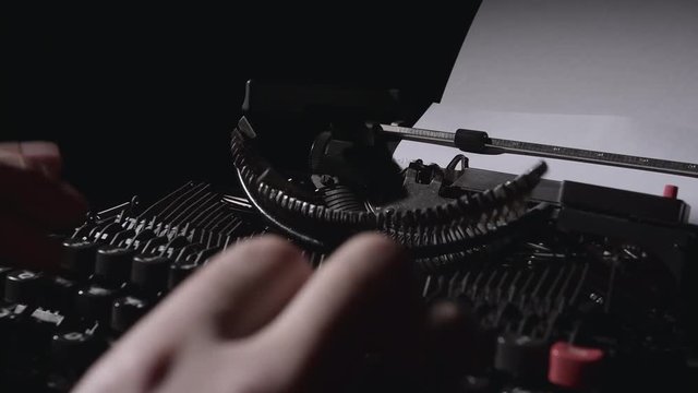 Poet types the text of the poem on a retro typewriter