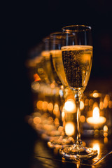 Champagne glasses at table setting with candlelight