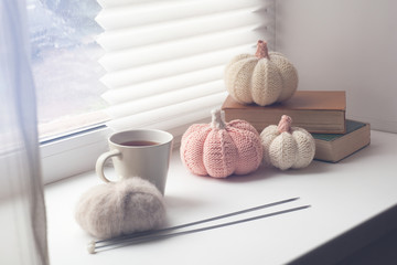 Autumn composition, knitted decor pumpkins, yarn and needle work, soft light