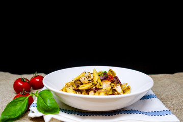 close-up of plate of pasta and chicken with lettuce