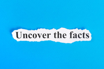 Fototapeta premium Uncover The Facts text on paper. Word Uncover The Facts on torn paper. Concept Image