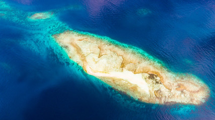 Small coral island near Raja Ampat . West Papua, Indonesia.