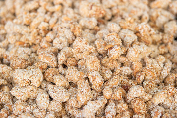 Detail of peanut in sesame dragees on a fair stall, selective focus