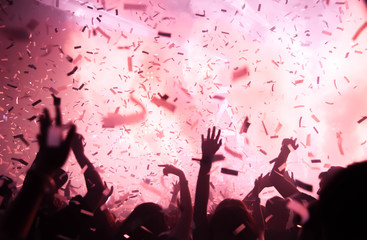 Silhouette hands of audience crowd people use smart phones enjoying the club party with concert....