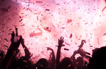 Silhouette hands of audience crowd people use smart phones enjoying the club party with concert....