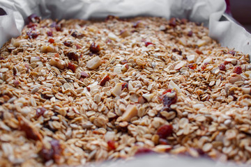 Oven roasted homemade honey granola on baking sheet