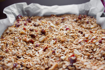 Oven roasted homemade honey granola on baking sheet