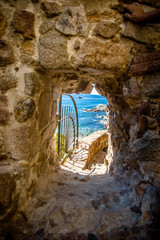 entrance to the beach through the ramparts in Tossa de Mar, Spain 